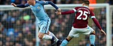 Manchester City playmaker Kevin De Bruyne (left) skips past Gudmundsson as he tries to start an attack for his side